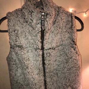 white fuzzy vest with olive green under tone
